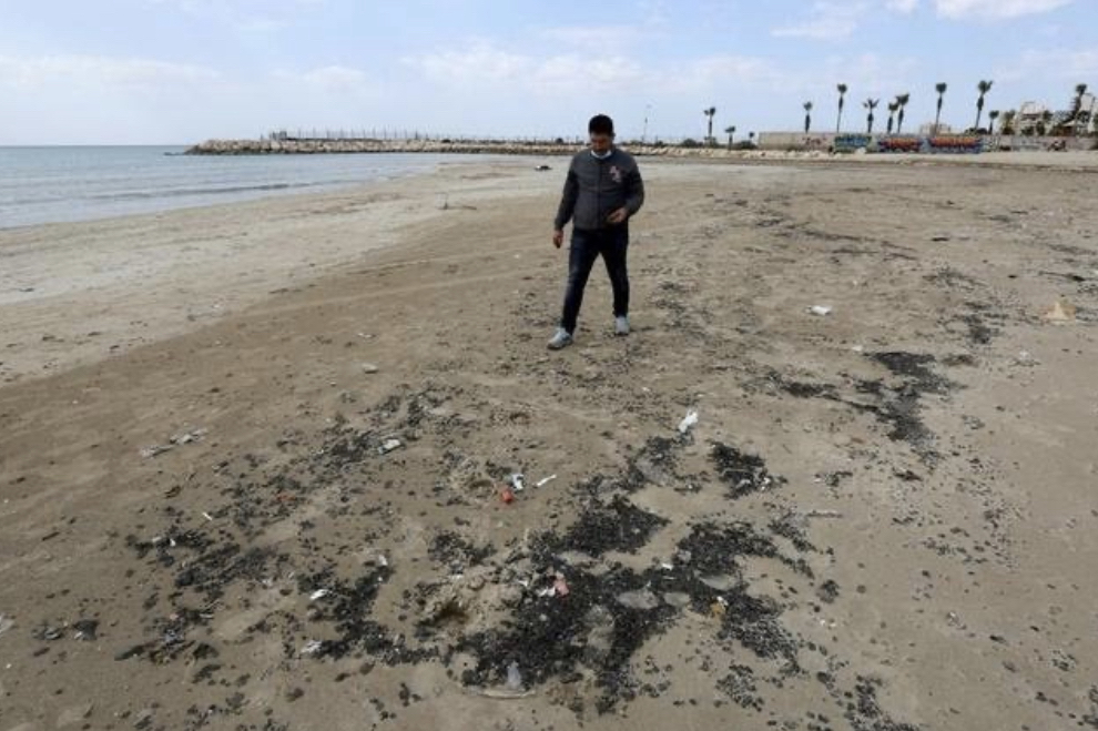 A man walks along a beach in the aftermath of an oil spill that drenched much of the Mediterranean shoreline in Tyre nature reserve, Lebanon February 22, 2021. (Photo by Reuters)